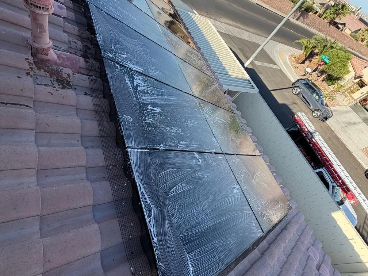 Solar array on a Las Vegas tile roof covered in cleaning suds mid-wash